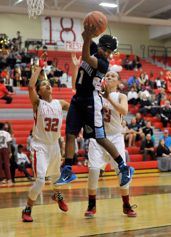 Centennial’s Pam Wilmore grabs a rebound against Arbor View’s Janae Strode (32) ...