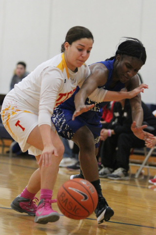 Tech’s Grace Malek, left, and Desert Pines’ Tanauya Hinton (14) fight for posses ...