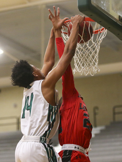 Rancho guard Trayvon Cotton-Taylor (14) dunks over Las Vegas forward Zion Edwards (22) durin ...