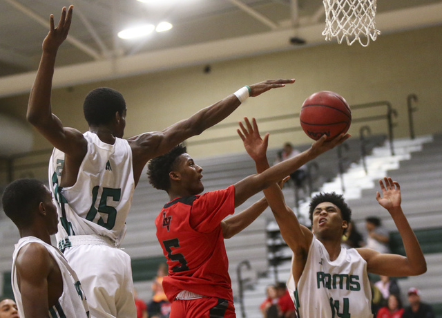 Las Vegas guard Deondre Northey (5) shoots between Rancho defense during a basketball game a ...