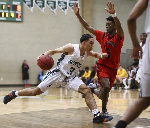 Rancho guard Chrys Jackson (3) drives against Las Vegas guard Deondre Northey (5) during a b ...