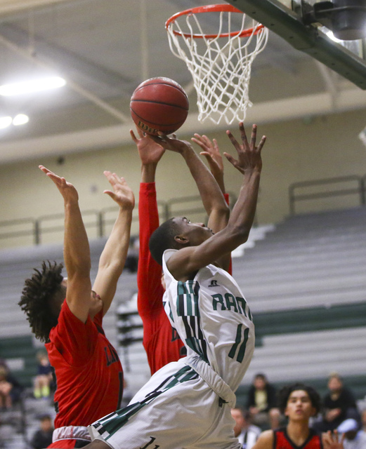 Rancho guard Dayshawn Robinson (11) goes up for a shot over Las Vegas guard Donovan Joyner ( ...