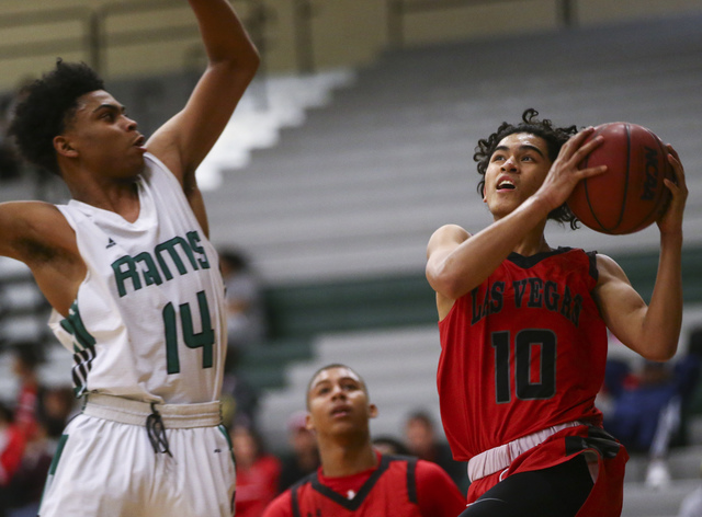 Las Vegas guard Josh Valencia (10) drives to the basket against Rancho guard Trayvon Cotton- ...