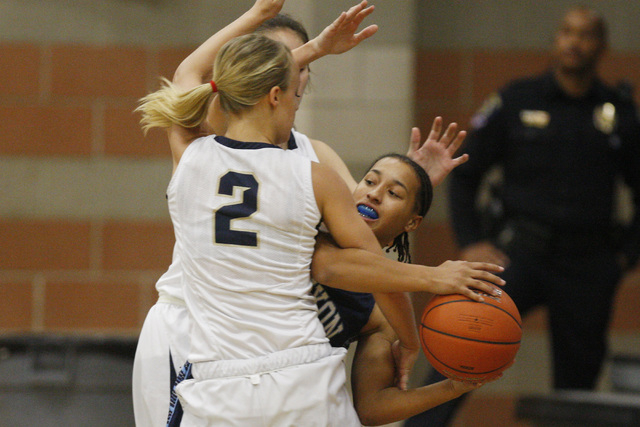 Canyon Springs’ Alize Bell is fouled by Foothill’s Mikayla Yeakel on Tuesday. Fo ...