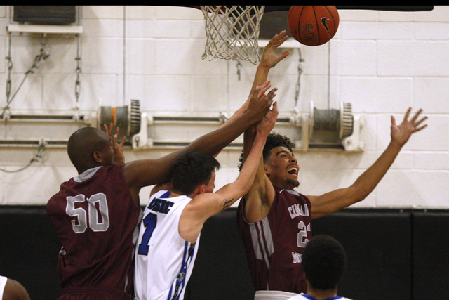 Cimarron-Memorial center Terrell Walker, left, and forward Jaron Ponder fight Basic guard Ja ...