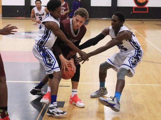 Basic forwards Robert Sutton, left, and Josh Villaros force Cimarron-Memorial center Joe Tit ...