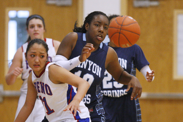 Canyon Springs forward Dre’una Edwards knocks the ball away from Reno guard Daranda Hi ...