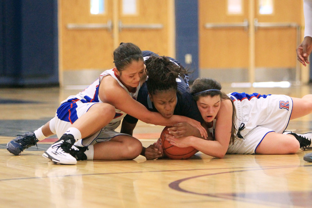 Canyon Springs guard Alexia Thrower fights for a loose ball with Reno guard Daranda Hinkey, ...