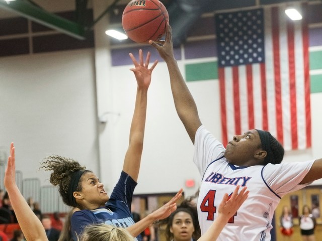 Foothills Rae Burrell (12) has her shot blocked by Liberty’s Dre’una Edwards (44 ...