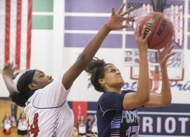 Foothill’s Rae Burrell (12) drives past Liberty’s Dre’una Edwards (44) dur ...