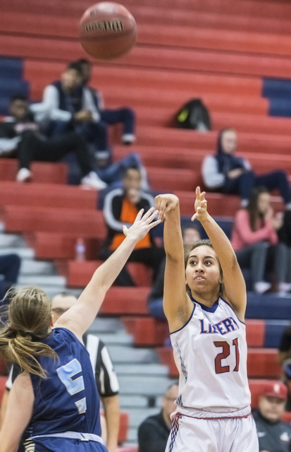 Liberty’s Kaily Kaimikaua (21) shoots a three point shot over Foothill’s Emily C ...