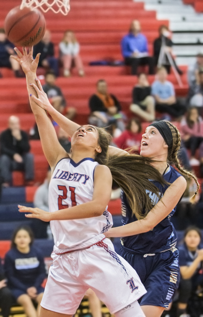 Liberty’s Kaily Kaimikaua (21) shoots a contested layup over Foothill’s Kylie Vi ...