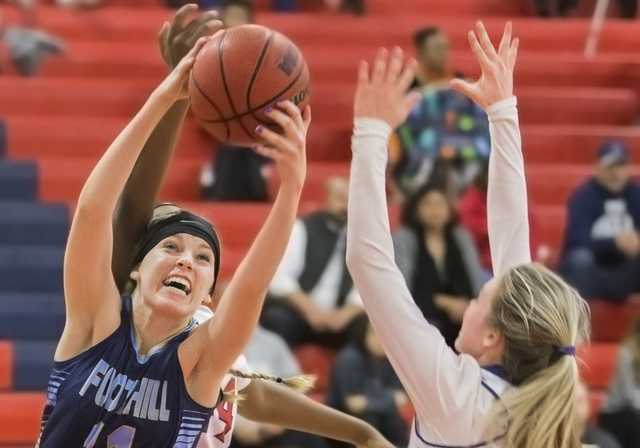 Foothills Kylie Vint (11) grabs a rebound over Liberty’s Dre’una Edwards (44) du ...