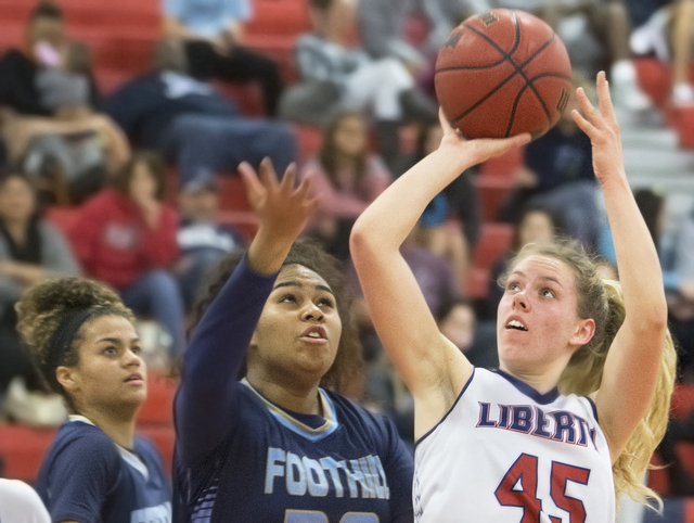 Liberty’s Amanda Pemberton (45) drives past Foothills Crystal Davis (30) during the Pa ...