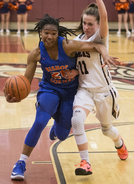 Bishop Gorman’s Skylar Jackson (20) drives past Desert Oasis’ Ashlynn Sharp (11) ...