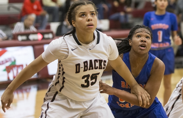 Desert Oasis’ Dajaah Lightfoot (35) fights for a rebound with Bishop Gorman’s Sk ...