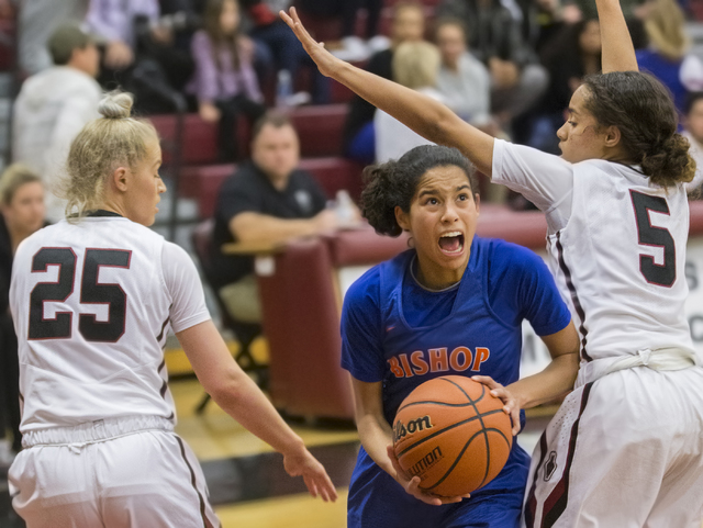 Bishop Gorman’s Shaira Young (2) splits Desert Oasis defenders Melissa Simmons (25) an ...