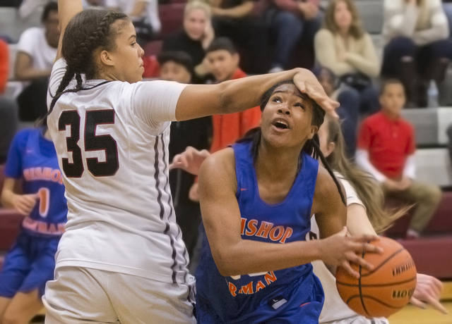 Bishop Gorman’s Skylar Jackson (20) gets fouled on the way to the basket by Desert Oas ...