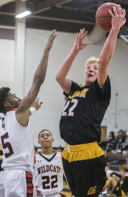 Clark’s Trey Woodbury (22) drives past Las Vegas’ Deondre Northey (5) during the ...