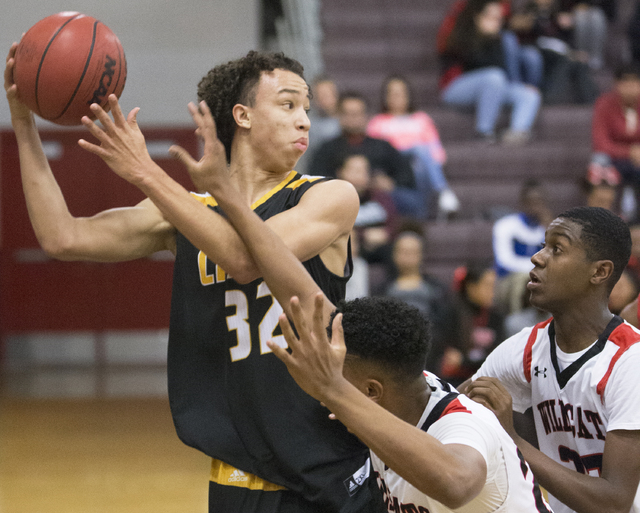 Clark’s Ian Alexander (32) fights for a loose ball with Las Vegas’ Zach Matlock ...