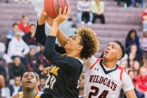 Clark’s Jalen Hill (20) slashes to the rim past Las Vegas’ Zach Matlock (24) dur ...