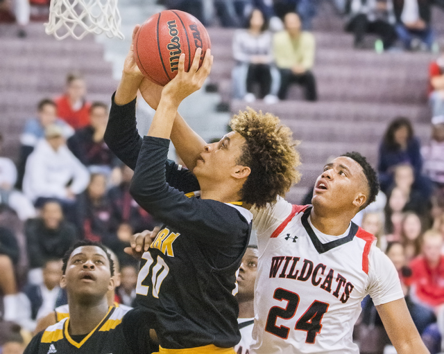 Clark’s Jalen Hill (20) slashes to the rim past Las Vegas’ Zach Matlock (24) dur ...