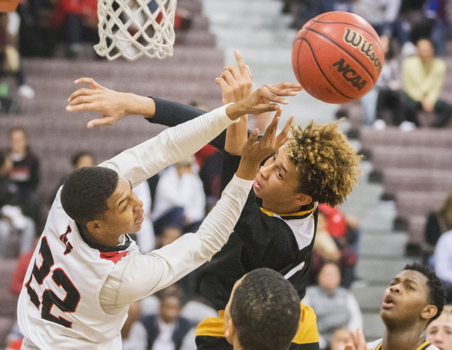 Clark’s Jalen Hill (20) fights for a loose ball with Las Vegas’ Zion Edwards (22 ...