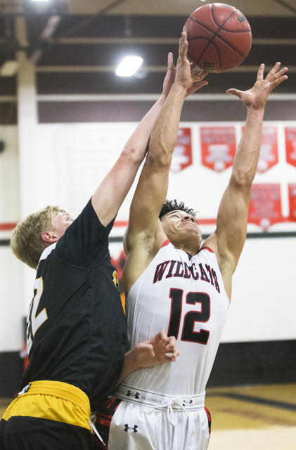 Las Vegas’ Donovan Joyner (12) fights for a rebound with Clark’s Trey Woodbury ( ...