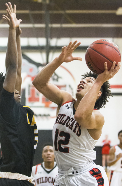 Las Vegas’ Donovan Joyner (12) drives to the rim over Clark’s Ian Alexander (32) ...