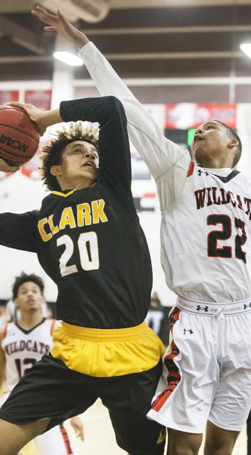 Clark’s Jalen Hill (20) drives to the rim over Las Vegas’ Zion Edwards (22) duri ...