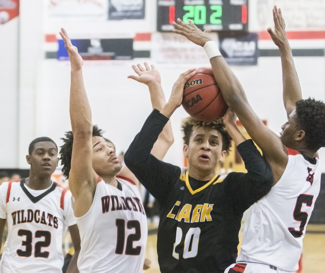 Clark’s Jalen Hill (20) drives to the rim past Las Vegas’ Kiaeem Gonzaque-Johnso ...