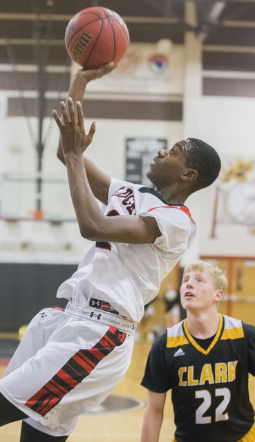 Las Vegas’ Kiaeem Gonzaque-Johnson (32) drives baseline past Clark’s Trey Woodbu ...