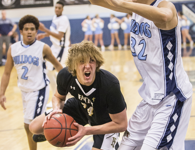 Faith Lutheran’s Nic Maccioni (24) battles for position in the key with Centennial&#82 ...