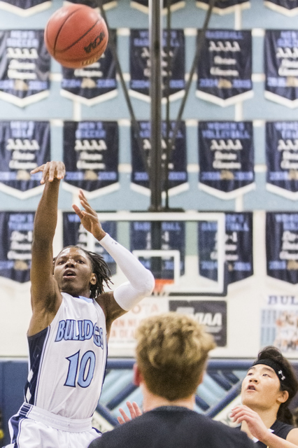 Centennial’s Isaiah Banks (10) shoots a jump shot over Faith Lutheran’s Elijah K ...