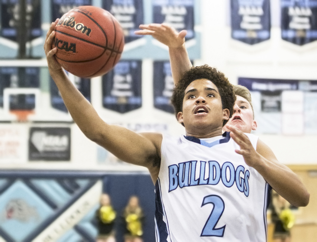 Centennial’s Alijah Henderson (2) drives past Faith Lutheran’s Brevin Walter (23 ...