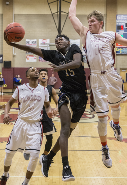 Sierra Vista’s Zekarias Kassaye (15) slices to the rim past Desert Oasis’ Jacob ...