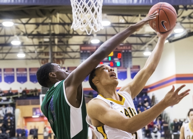 Clark’s Tony Lang (5) drives past Chino Hills’ Onyeka Okongwu (21) during the Ta ...