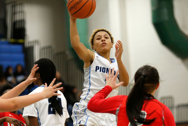 Canyon Springs’ Aleza Bell, center, shoots over Arbor View’s Kalli Hosier, right ...