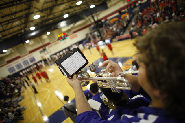 Bishop Gorman’s Christian Strysniewiez plays the trumpet during a basketball game at B ...