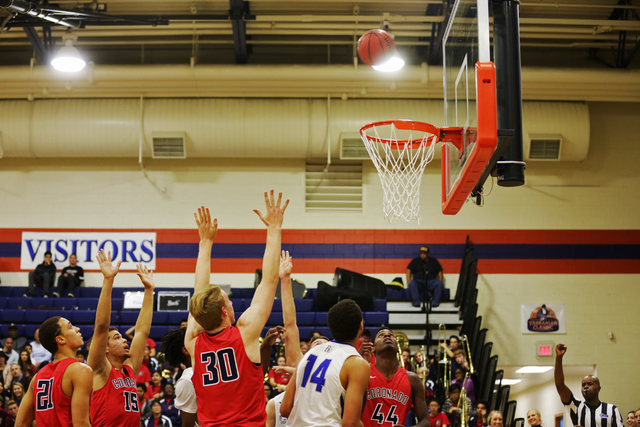 Both Bishop Gorman and Coronado teams wait to catch a rebound during a basketball game at Bi ...