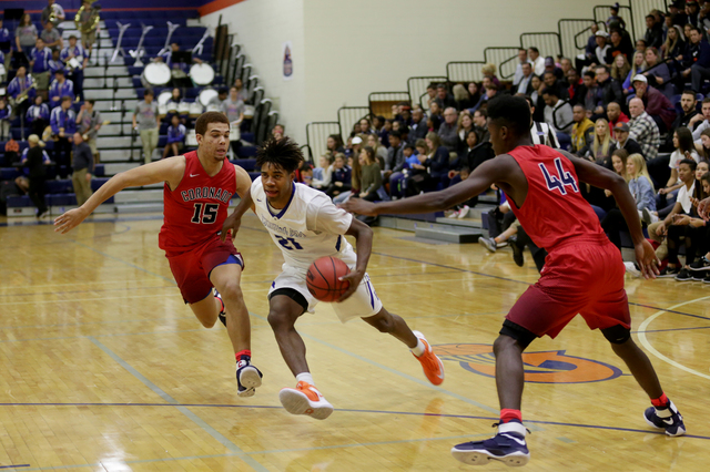 Bishop Gorman’s Christian Popoola (21) attempts to push past Coronado’s guard Br ...