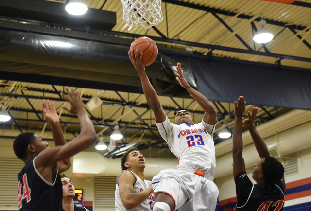 Bishop Gorman’s Nick Blair (23) shoots the ball over Corona Centennial defenders durin ...