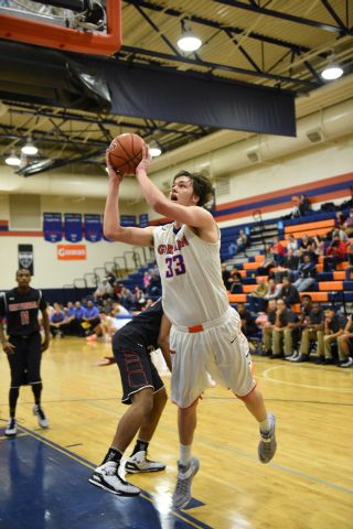 Bishop Gorman’s Stephen Zimmerman (33) shoots the ball overCorona Centennial defenders ...