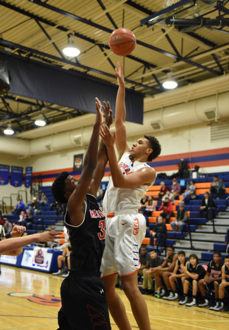 Bishop Gorman’s Chase Jeter (4) shoots the ball over Corona Centennial’s Jalen H ...