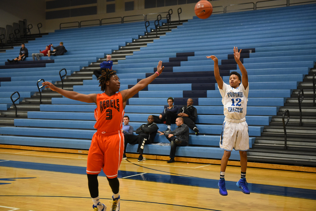 Foothill’s Eric Johnson (12) goes up for a shot over National Prep Academy’s Isi ...