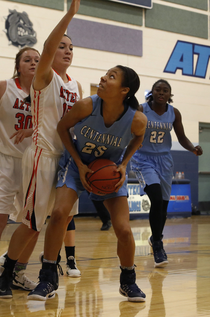 Centennial’s Samantha Thomas (25) looks for a shot during a high school basketball ga ...