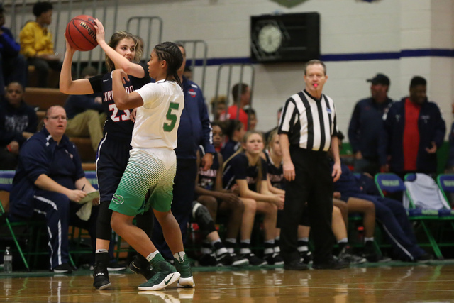 Coronado senior Payton Caci (23), left, attempts to pass the ball as Green Valley sophomore ...