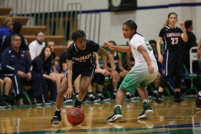 Coronado sophomore Tia Thornton (11), left, makes her way around Green Valley sophomore She ...