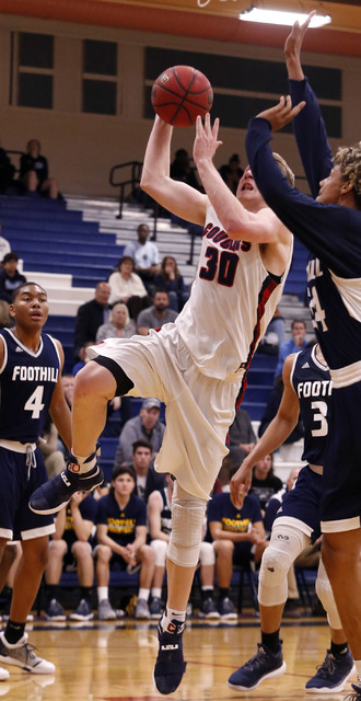 Coronado’s Kennedy Koehler (30) shoots a layup over Foothill’s Carl Fischer (34) ...