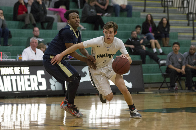 Palo Verde junior Mitchell Olsen drive the ball against Shadow Ridge senior Kevin Branch at ...